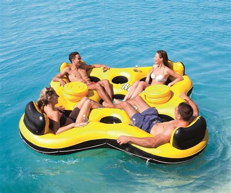 Four People Are Floating On An Inflatable Raft