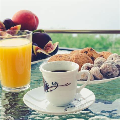 Breakfast Table With Coffee Orange Juice Fruits And Croissants Stock