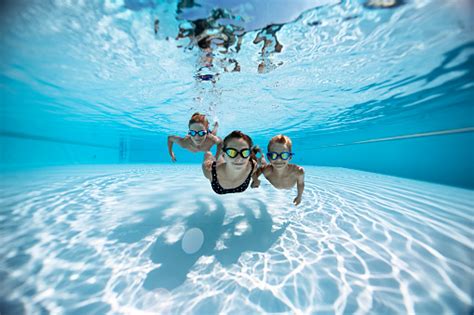 Three Happy Kids Swimming Underwater In Pool Stock Photo Download