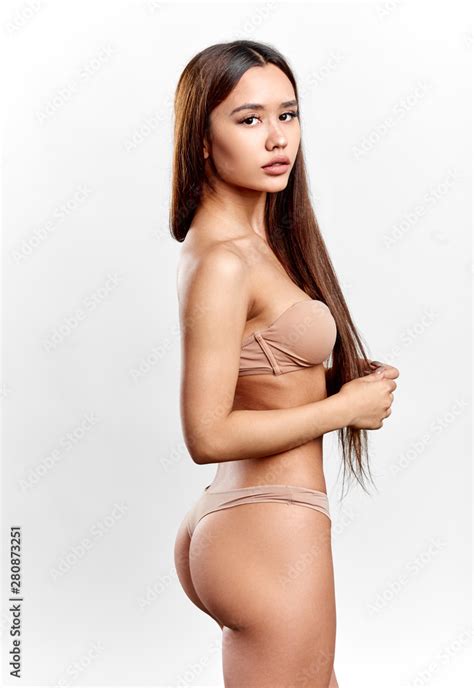 Serious Asian Woman In Fashion Lingerie Demonstrating Her Nude Body