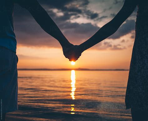 Couple Holding Hands On Nature Beach On Sunset By Ilya Couple