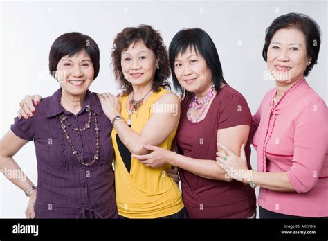 Portrait Of Three Senior Women And A Mature Woman Standing Together And