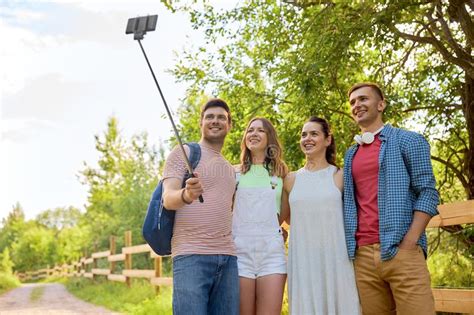 Friends Take Picture By Smartphone On Selfie Stick Stock Photo Image