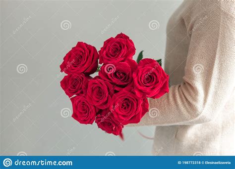 Woman Holding Fresh Blossoming Flower Bouquet Of Red Roses Copy Space