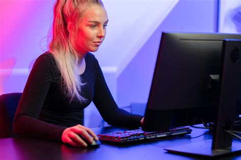 Focused Blonde Gamer Girl Playing Online Video Game On Her Personal