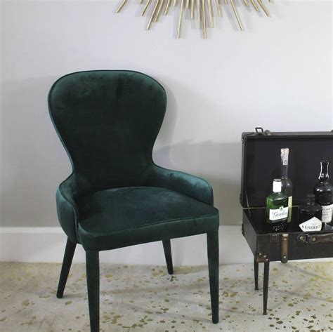This is the classic and contemporary style accent chair with wingback. Stunning cocktail chair, upholstered with a rich emerald ...