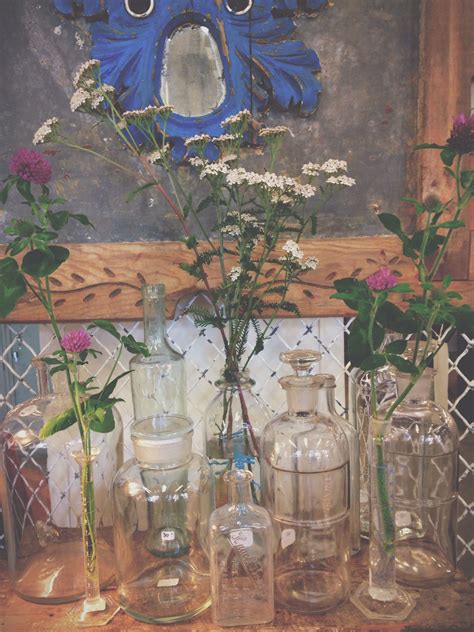 Several Vases With Flowers In Them Sitting On A Table Next To A Wall