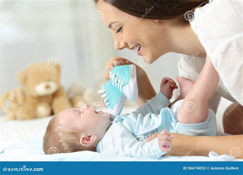 Mother Showing New Shoes To Her Baby Stock Image Image Of Childhood