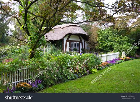 Charming English Style Cottage In The Garden Stock Photo 106669571