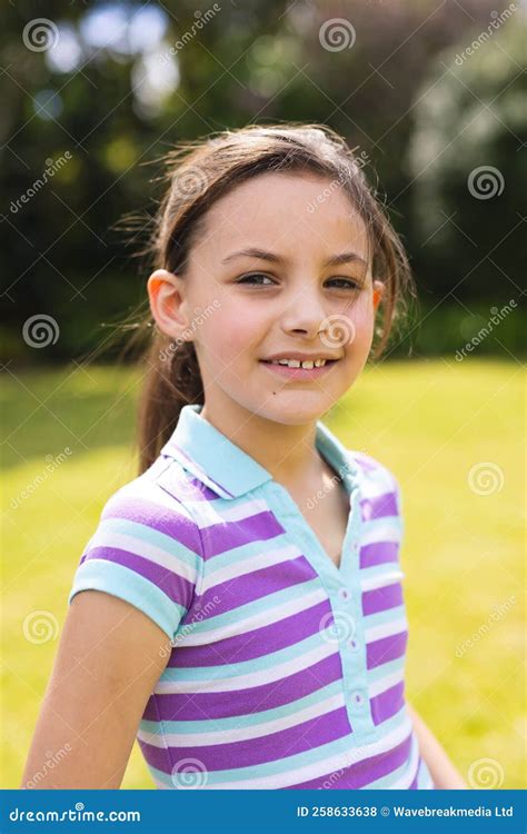 Vertical Portrait Of Young Caucasian Girl Wearing Striped T Shirt And