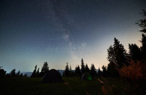 Night Starry Sky Over Mountain Hill With Camp Tents Stock Photo