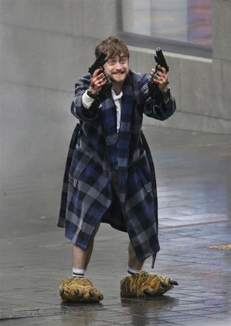 Check out the official trailer for jungle, starring daniel radcliffe! Photo Of Daniel Radcliffe Holding Guns In Crazy Slippers ...
