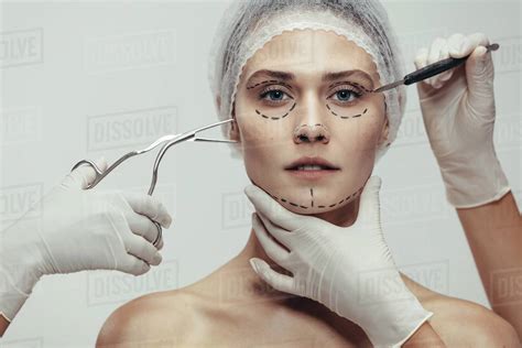 Close Up Of Woman Having Cosmetic Face Surgery With Scalpel And Medical