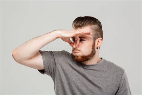 Young Handsome Man Pinching Nose Over Grey Background Copy Space