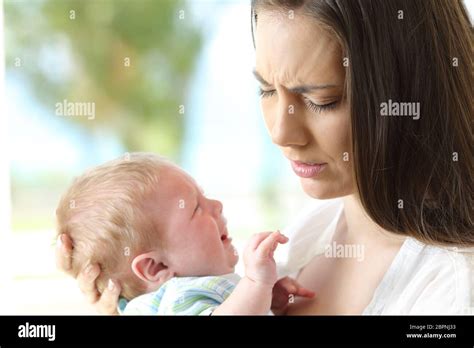 Tired Desperate Mother Holding Her Baby Crying Stock Photo Alamy