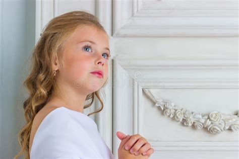 A Beautiful Little Girl Angel In White Robe Praying Stock Photo Image