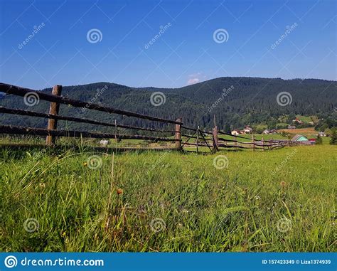 Beautiful Summer Countryside Landscape With Forested Hills Grassy