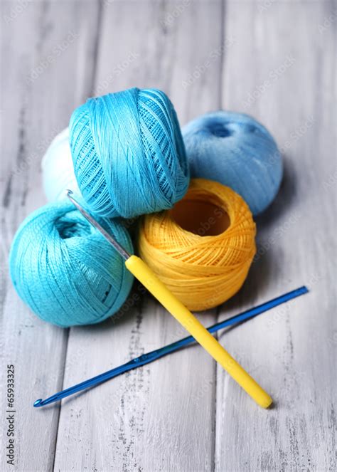 Colorful Clews And Crochet Hook On Wooden Background Stock Photo