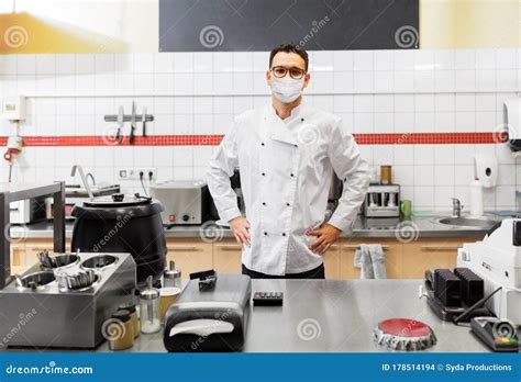 Male Chef With In Face Mask At Restaurant Kitchen Stock Photo Image