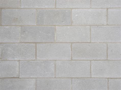A seamless concrete texture with polished concrete blocks arranged in a stack pattern. Integrity Masonry - Services