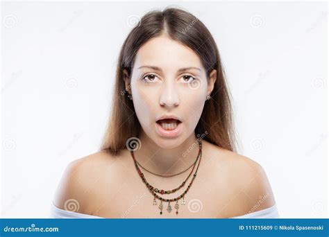 Surprised Brunette Girl Wearing A Necklace With Generic Symbols Stock