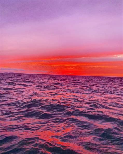 An Orange And Purple Sunset Over The Ocean