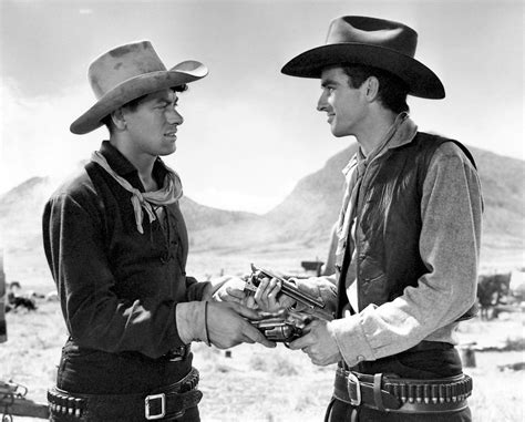 John Ireland And Montgomery Clift Handling Each Others Guns In Red