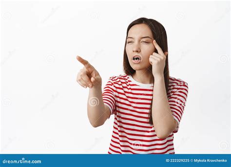 Image Of Girl Cant See Without Glasses Squinting Eyes And Pointing At