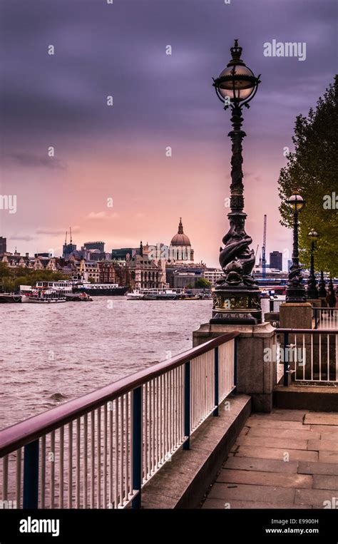 A Railing At The Waters Edge Of The Thames River Leads The The Icon