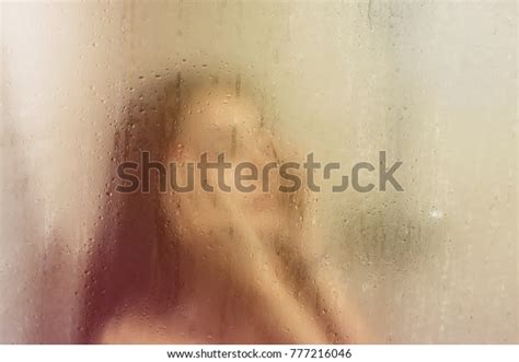 Beautiful Woman Shower Behind Glass Drops Stock Photo