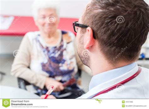 Doctor Seeing Senior Patient In Practice Stock Image Image Of Patient