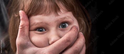 A Frightened Young Girl With A Grown Mans Hand Covering Her Mouth