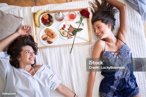 Top View Of Lesbians Smiling Holding Hands Having Breakfast Lying On