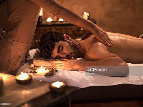 Young Man Enjoying With Eyes Closed During Back Massage High Res Stock