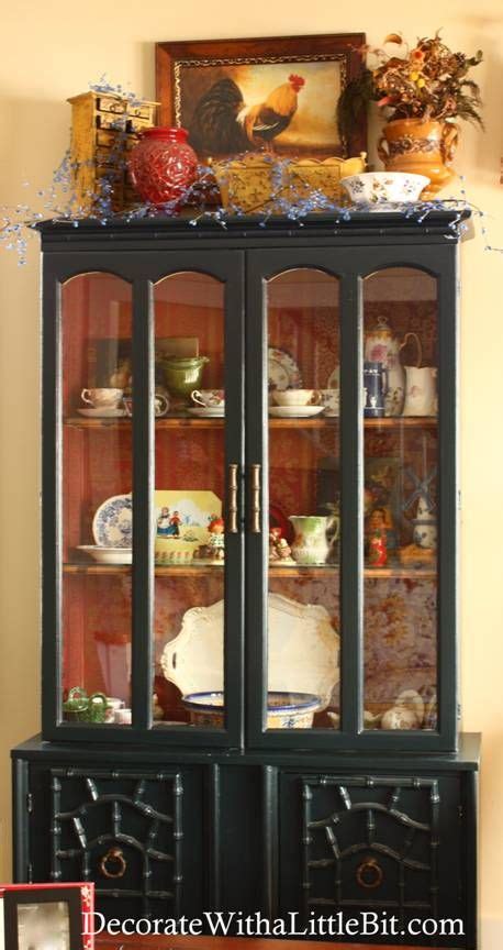 Ditch the hummel figurines and fill it with coral, antlers, and plants for a cabinet of curiosity look. black cabinet with wallpaper inside | Kitchen cabinets ...