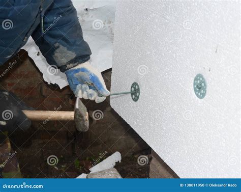 Builder Contractor Installing Rigid Styrofoam Insulation Board With