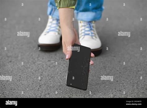 Woman Taking Dropped Smartphone From Asphalt Closeup Device Repairing