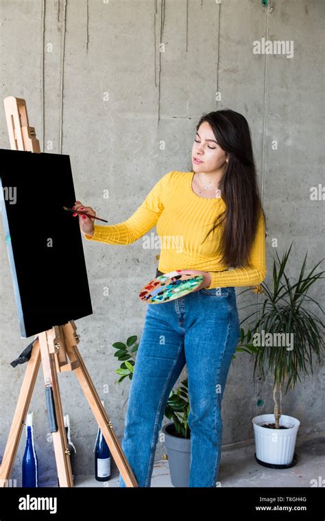 Young Lady Painter Artist With Isolated Canvas Artwork Mock Up On Easel