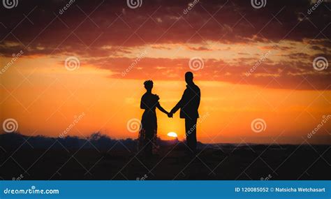 Silhouette Of Couple Lovers Bride And Groom Holding Hands During