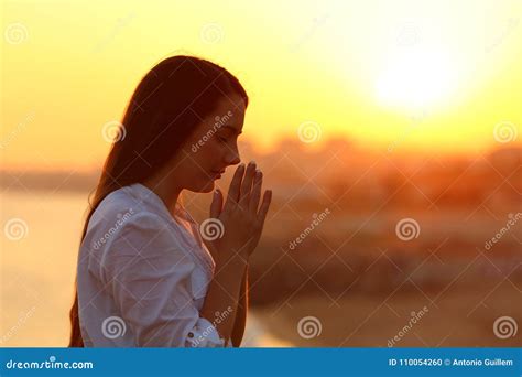 Side View Of A Woman Praying At Sunset Stock Photo Image Of Landscape