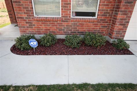 If you prefer not using chemicals, mix baking soda and water in a garden sprayer and spray the rocks evenly. red lava rocks | Lava rock landscape, Landscaping with ...