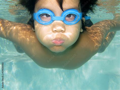Underwater Healthy Active Young Boy Fun In Swimming Pool With Goggles