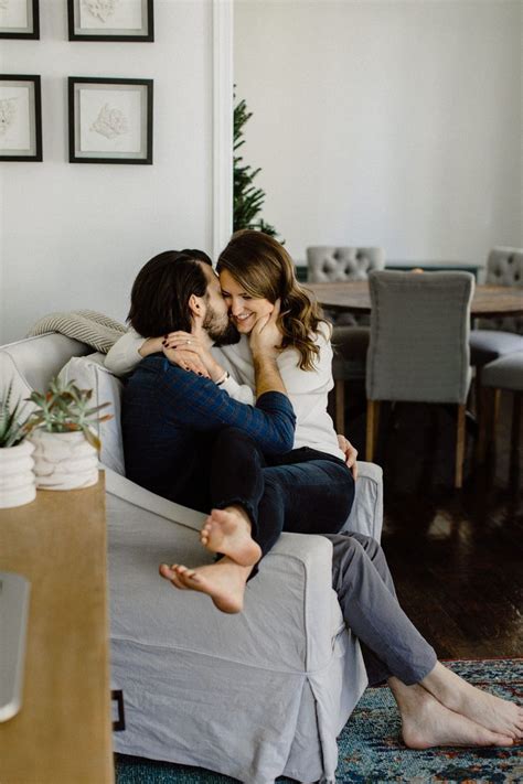 Couple Snuggling On A Couch Inside Engagements Inside Lifestyle Photography In Home Photography