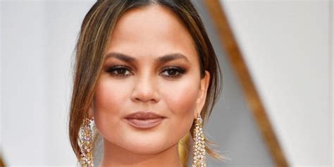 chrissy teigen says she s getting her breast implants removed