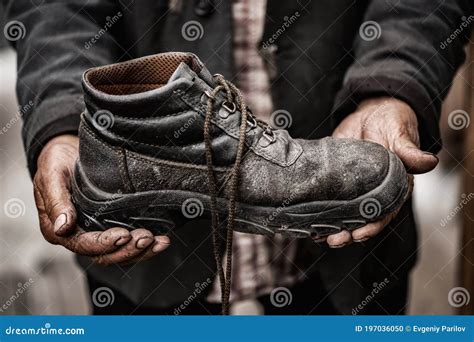 Homeless ManÂ´s Rotten Shoes With Dirty Feet On Urban Environment Stock