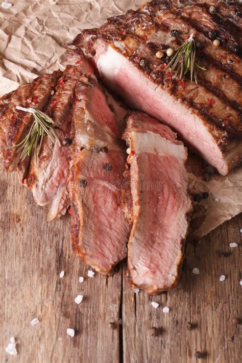 Sliced Grilled Beef Steak On A Wooden Vertical View Above Stock Image