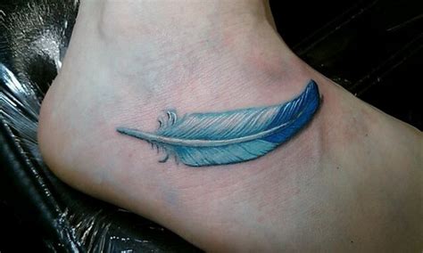 Metallic, glitter & glow available. Cute small blue feather tattoo on foot - Tattooimages.biz