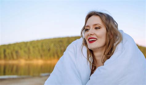 Wind In Hair Young Bride Happy Wrapped In A White Blanket Stands On