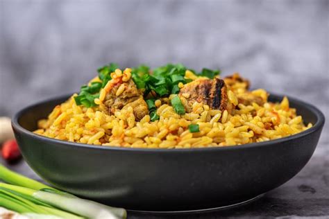 Rice Pilaf With Meat Carrot And Onion On Grey Background Top View