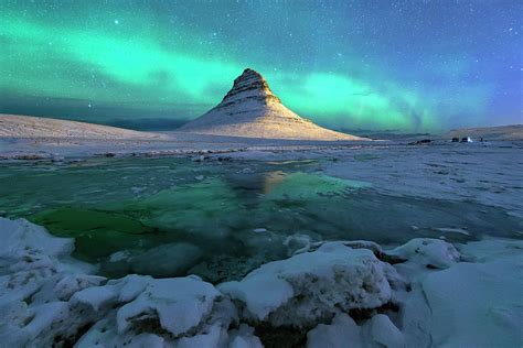 Aurora Over Kirkjufell Mountain Iceland By Ratnakorn Piyasirisorost